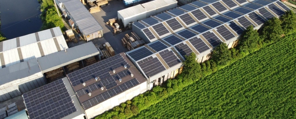 Luchtfoto van de loodsen van Houthandel Devreese met zonnepanelen