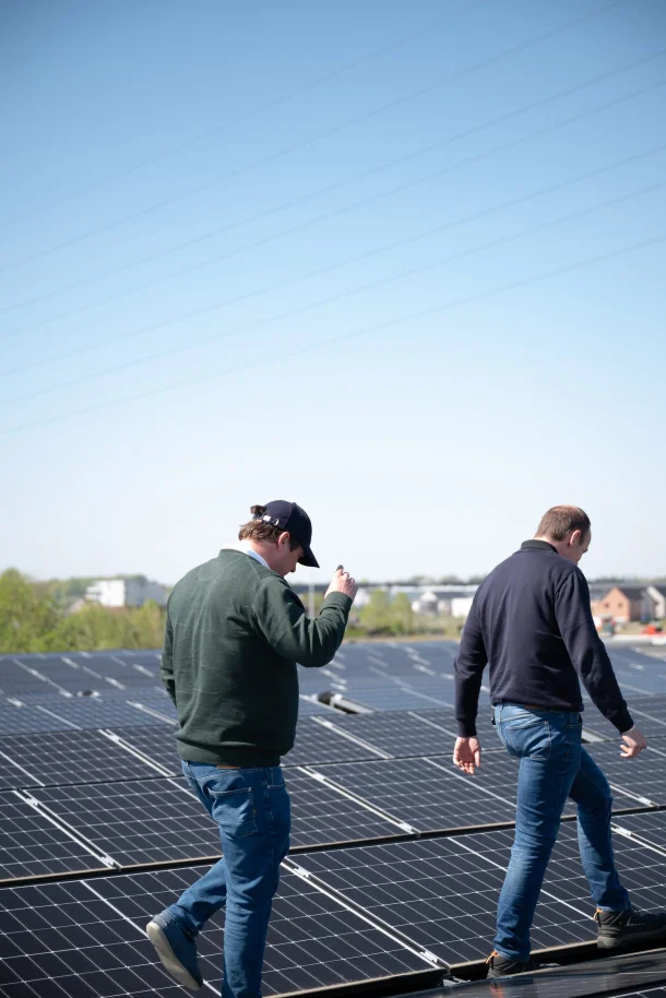 Medewerkers lopen over het zonnedak tijdens een controle
